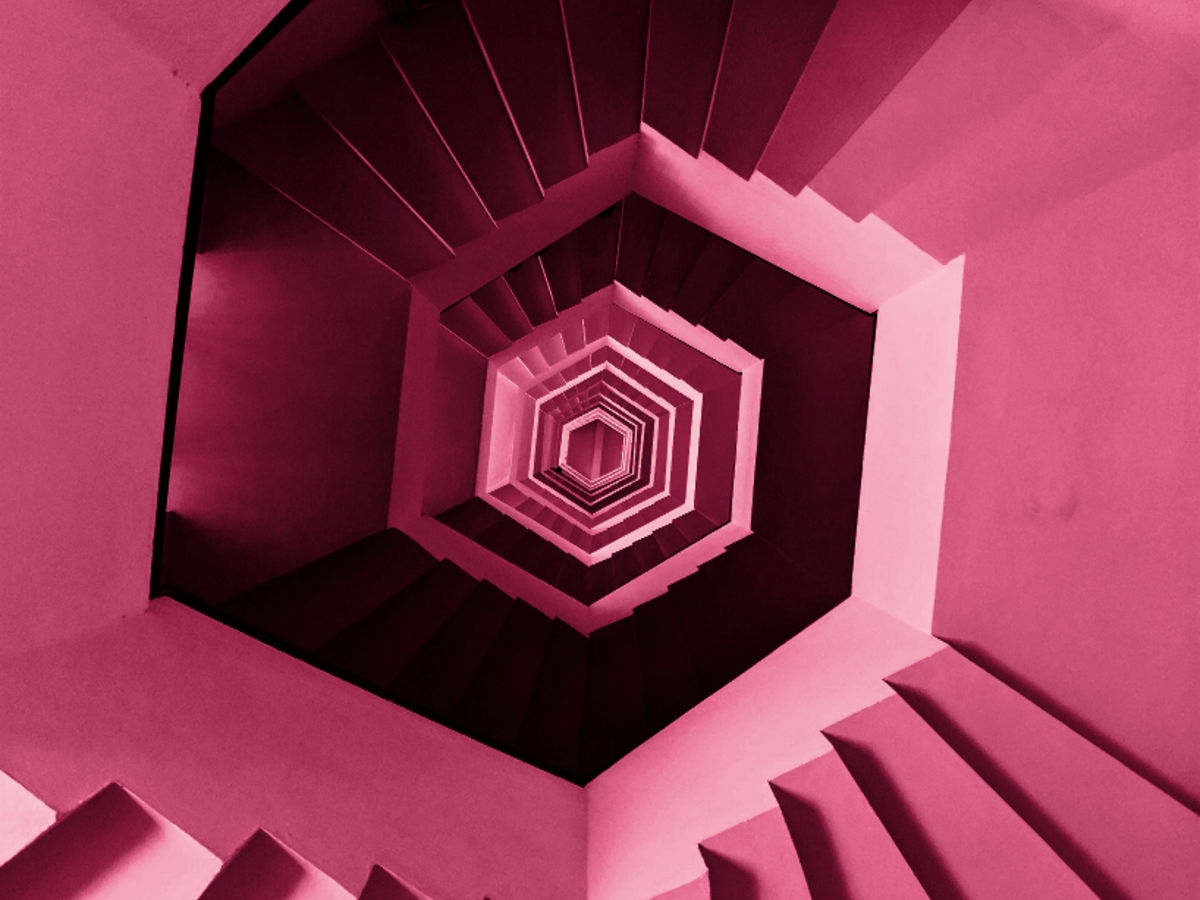 red toned spiral staircase from top down view