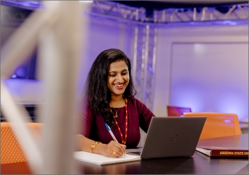 Student at a desk using a laptop 